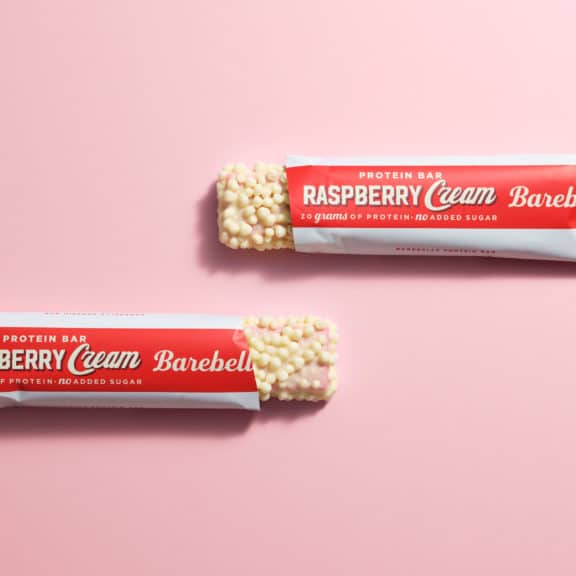 Raspberry Cream Bars lifestyle with pink background